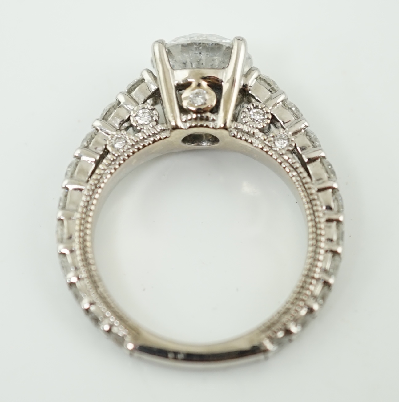 A modern 18ct white gold and single stone diamond set ring, with twenty eight graduated diamond set shank and setting